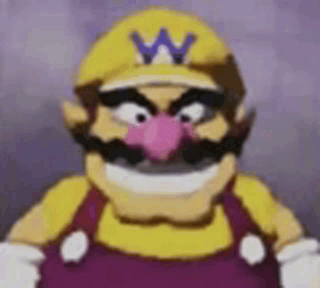 a close up of a cartoon character wearing a yellow hat with a w on it and a pink nose .