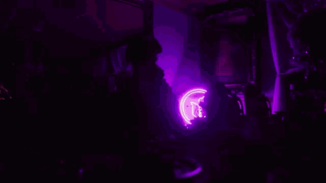 a man with glasses sits at a table with a purple background that says cland nancy