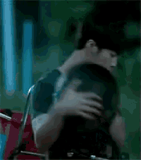 a man is hugging a woman in a wheelchair .