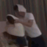 a blurry picture of a man and woman hugging each other .