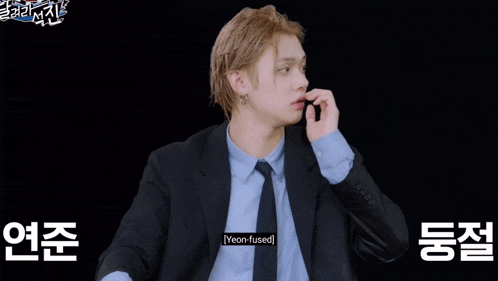 a man in a suit and tie has the word yeon-fused on his shirt pocket