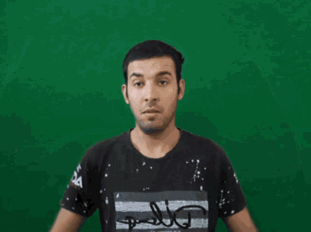 a man flexes his muscles in front of a green screen while wearing a t-shirt that says bounce on it