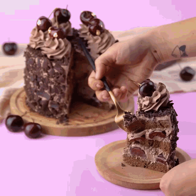 a person taking a slice of cake with a fork