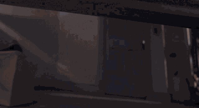 a cartoon character with blue hair and a beard is peeking out from under a table