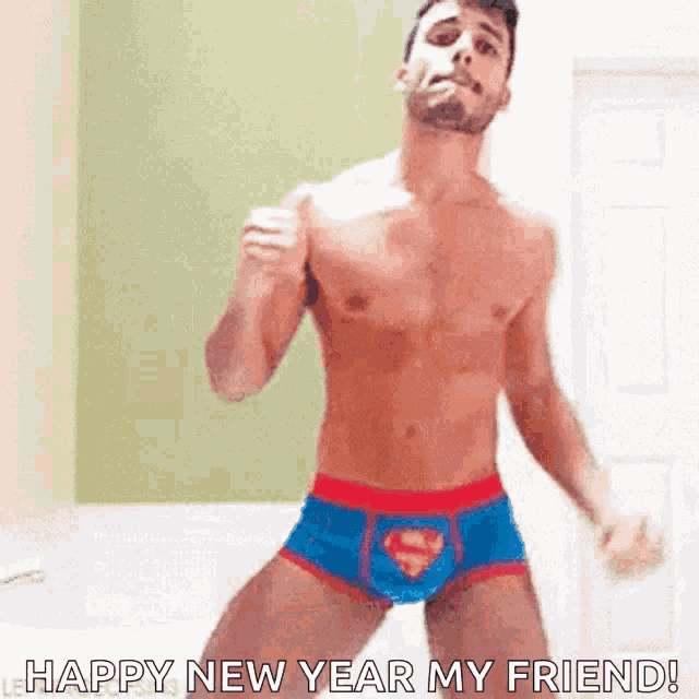 a shirtless man in superman underwear is dancing in a room .