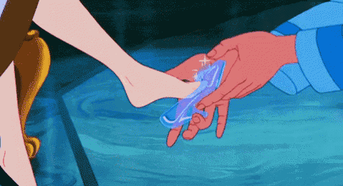 cinderella 's foot is being put into a glass shoe