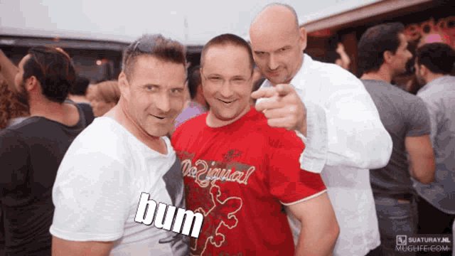a group of men are posing for a photo and one of them is wearing a shirt that says bum