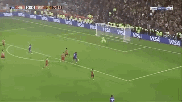 a soccer game is being played on a field with visa advertisements