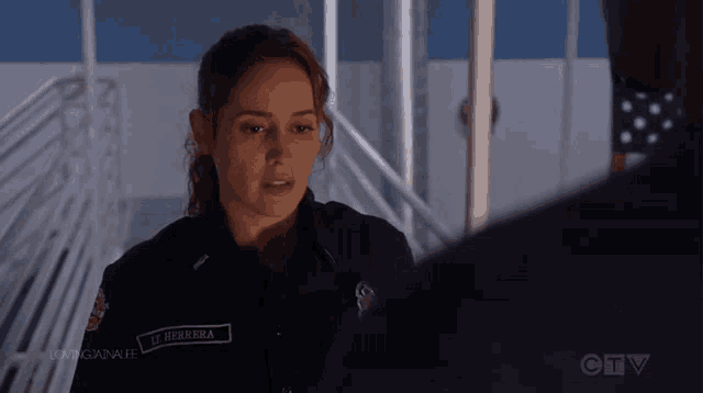 a woman in a firefighter uniform has a patch that says j. herrera