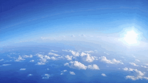 the sun is shining brightly through the clouds in the blue sky