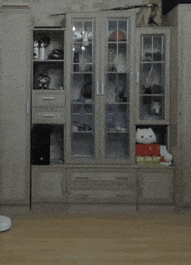 a man wearing a virtual reality headset is standing in front of a cabinet