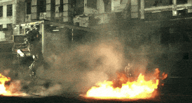 a truck is on fire in front of a building that says ambulance