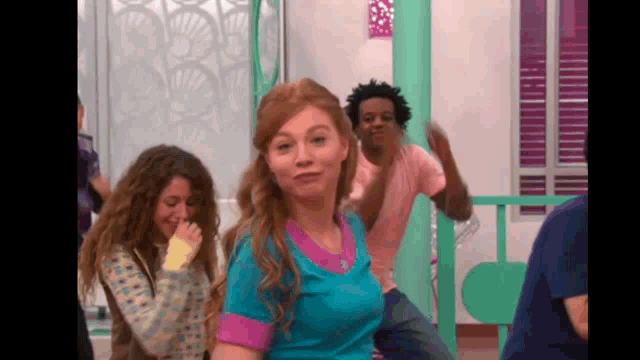 a group of people are dancing in a room and one of them is making a funny face