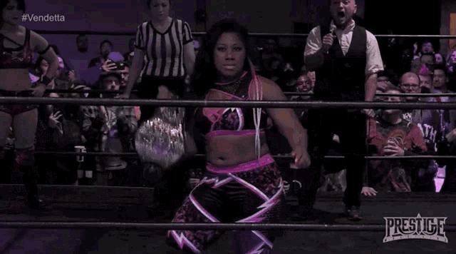 a woman in a wrestling ring with the word prestige on the bottom right