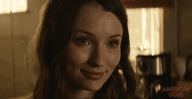 a close up of a woman 's face with the words american gods above her
