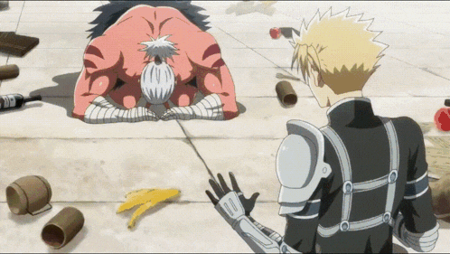 a man in armor is standing next to a man kneeling down