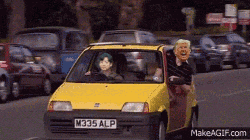a small yellow car with a license plate that says m335 alp