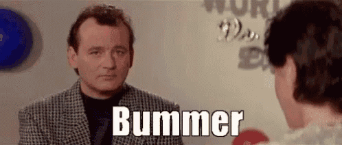 a man in a suit is talking to a woman in a room and the man is saying bummer .