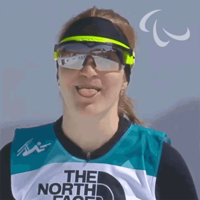 a woman wearing sunglasses and a north face shirt