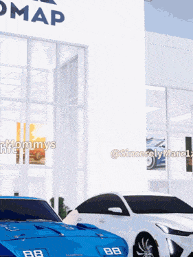 a blue car with the number 88 on the front is parked next to a white car