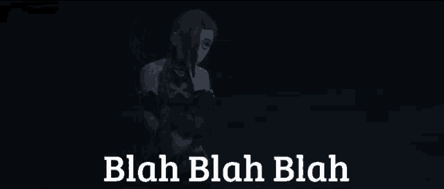 a girl with long hair is standing in the dark with the words `` blah blah blah '' .