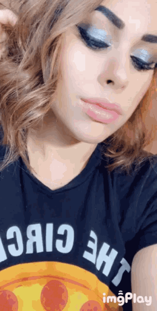 a woman wearing a black t-shirt that says " the choice " takes a selfie
