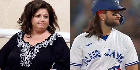 a woman and a blue jays baseball player are sitting next to each other