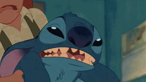 a close up of a cartoon character with its mouth open .
