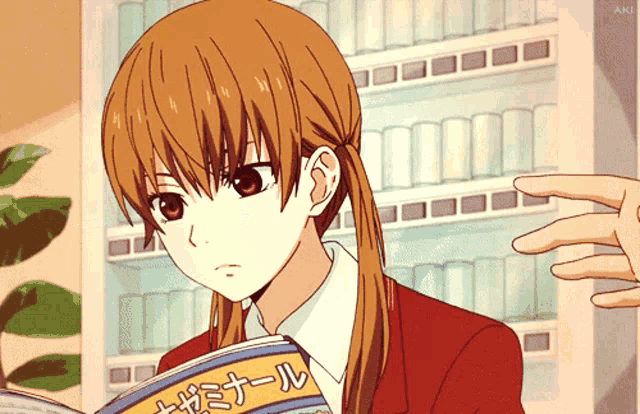 a girl in a red jacket is reading a book with foreign writing