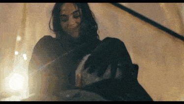 a woman is standing next to a man in a dark room .