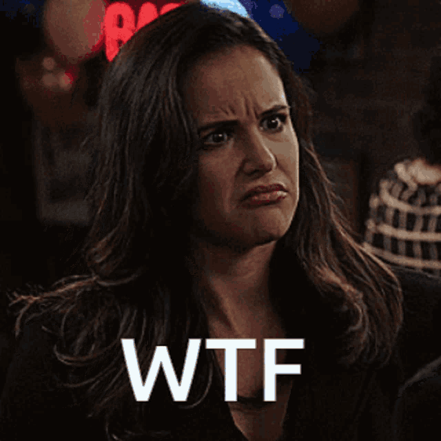 a woman is making a funny face and the word wtf is above her head