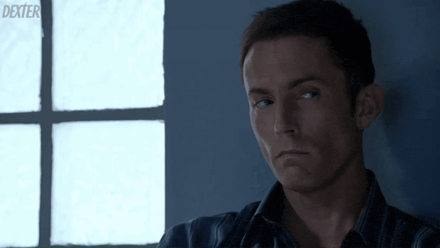 a close up of a man 's face with the word dexter on the bottom