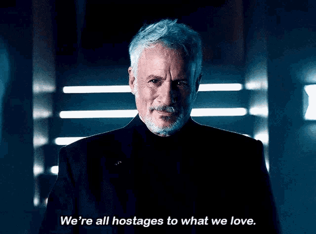 a man with gray hair and a beard says we 're all hostages to what we love