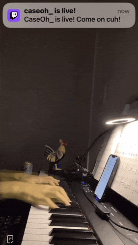 a person is playing a piano with a notification that says caseoh is live