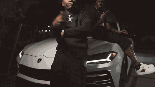 a man in a black hoodie has a necklace that says t.i.p. on it