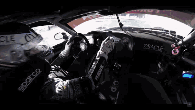 two cars are racing on a race track and one has the word formula on it