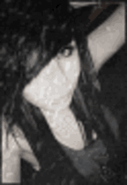 a black and white photo of a woman with blue eyes and black hair