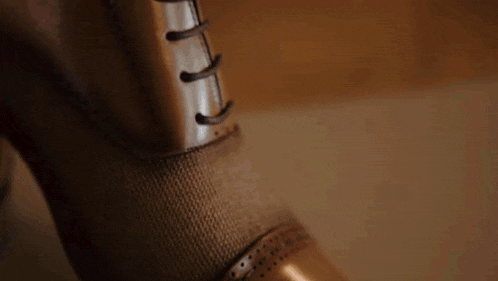 three men 's shoes are lined up next to each other on a table