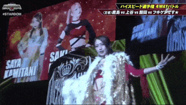 a female wrestler is standing in front of a large screen that says #stardom