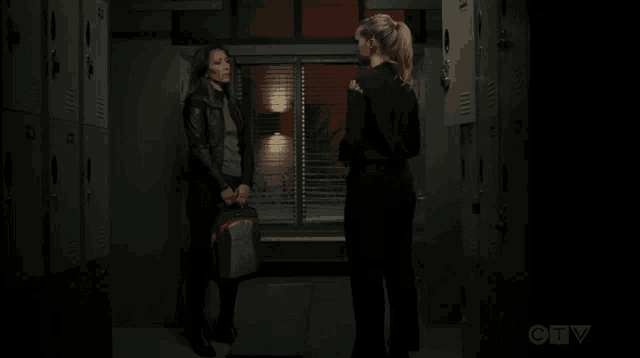 two women standing next to each other in a dark room with a ctv logo on the bottom right