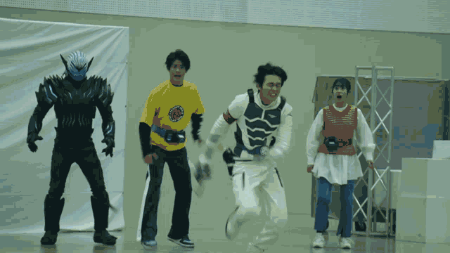 a man in a white costume with wings is standing in front of a group of people