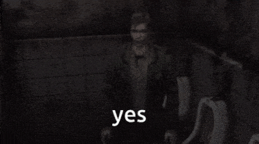 a man in a green jacket stands in front of a urinal with the word yes written in white