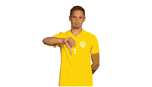a man in a yellow shirt with the number 7 on it giving a thumbs down sign