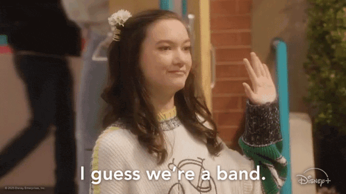 a woman with a flower in her hair says i guess we 're a band .