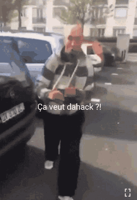 a man is walking down a street with the words ca veut dahack on the bottom