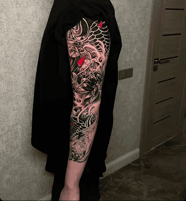 a man has a tattoo on his arm that looks like a dragon