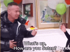 a man in a black jacket says what 's up how are you satan while holding his stomach