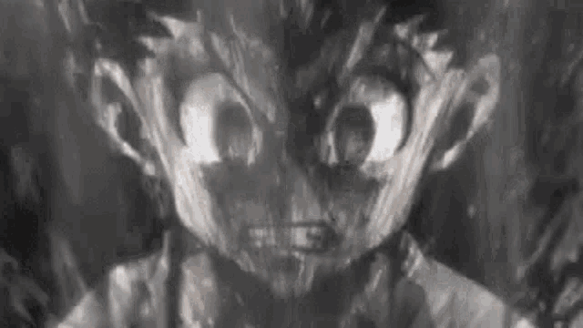 a close up of a person 's face with a very angry look on their face in a black and white photo .