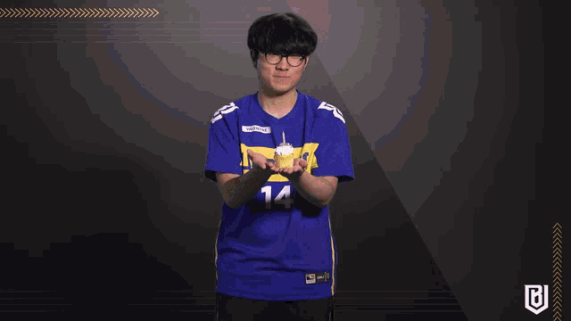 a man wearing a blue jersey with the number 14