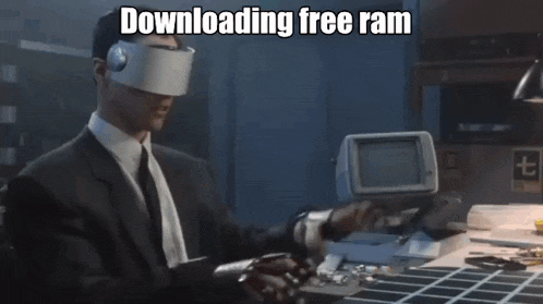 a man in a suit and tie wearing a virtual reality headset is using a computer .